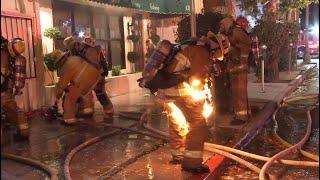 Firefighter catches fire while battling a structure fire in Sherman Oaks California. Not injured.