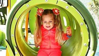 Little girl Diana have fun playing on the Outdoor playground Kids video