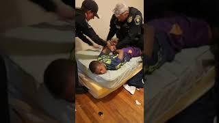 Jabari restrained by police officer
