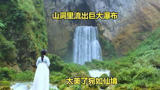 A huge natural waterfall flows out of a cave in the deep mountains of Guizhou like a fairyland