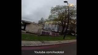 Looks like disgusting beggars pee or pooping on a tree at marble arch and throwing something away.