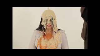 Woman covered in rice pudding and beans