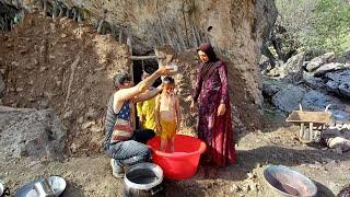 Bathing of children by nomadic parents in a traditional way