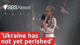 Seven-year-old girl sings Ukrainian national anthem in moving charity event performance  SBS News