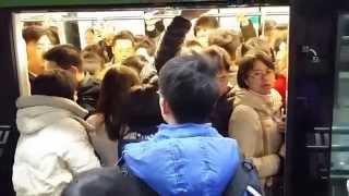 Chinese Ayi gets packed into metro train.