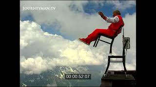 Elderly Daredevil Chair-Balancing on Mountain