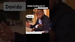 Chioma laughs at Davido as he feeds one of the twins and struggle to use his phone #davido