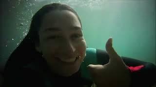 Close up of girl playing in the surf in a wetsuit