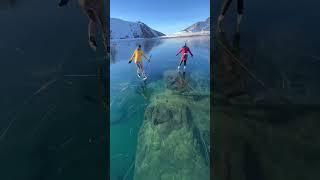 Skating over the clear glassy ice of rabbit lake in Canada