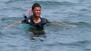 Ceuta Migrant boy swims to shore with plastic bottles tied to himself