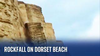 Dorset Rockfall on a beach narrowly misses people walking below