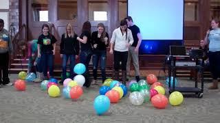 Group of People Stomping Balloons