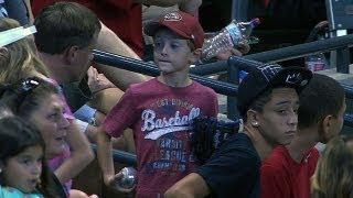 Kid misses ball another gives him souvenir