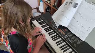 Sienna playing piano.