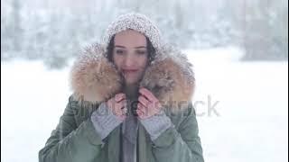 Woman in a snowy forrest in a fur parka