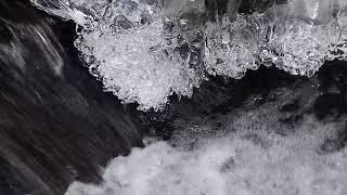 in cold ice water flowing by DSLR