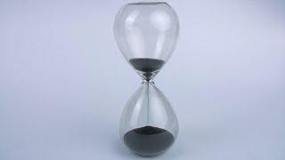 Closeup shot of a modern transparent hourglass flowing black s...  Indian Stock Footage  Knot9