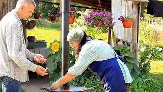 Cooking a rustic dinner over a campfire. Simple life of a family in a remote village