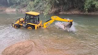 jcb going into a river for sand extraction