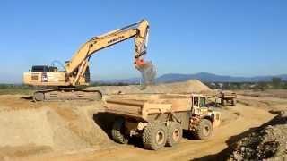 Big excavators on construction sites...Cat Komatsu Liebherr...