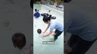 BABY SWIMMING IN THE POOL WITH MOM