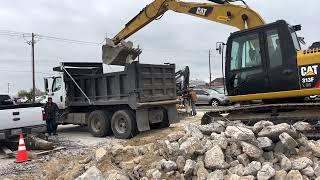 Busting up concrete for a parking lot .