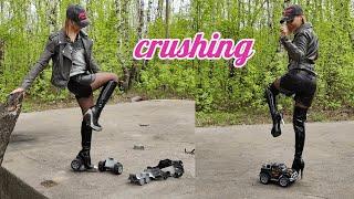 Crushing a toy car with the metal heels of boots breaking the heel in half 