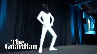 Elon Musk unveils plan for Tesla Bot with man dancing in a bodysuit