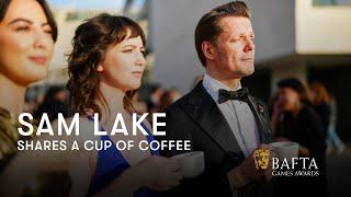 Sam Lake has a cup of coffee on the red carpet  BAFTA Games Awards 2024