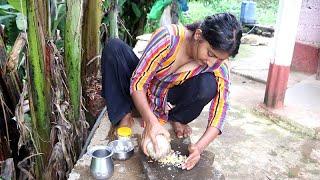 village girl cooks chicken gravy with traditional spices on firewood stove