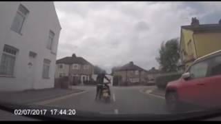 DASH-SCAM Dashcam footage reveals bizarre moment biker rams moped into car