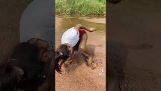 Girl Catching Eel in Mud Water