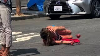 Venice Beach crazed painted red girl out of control during the homeless cleanup near Golds Gym.