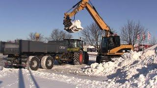 CAT M316D loading snow on CLAAS 650 Arion and John Deere 5100R