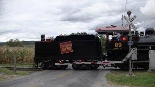 Vintage Steam Locomotive reverses through crossing with old gates