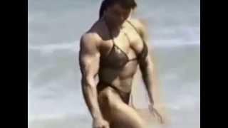 Curvy female bodybuilder at the beach