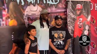 RAIDERS RB TAKING PHOTOS AT HIS ANNUAL YOUTH FOOTBALL CAMP