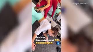 Olivia Culpo on the floor exhausted in bikini after workout