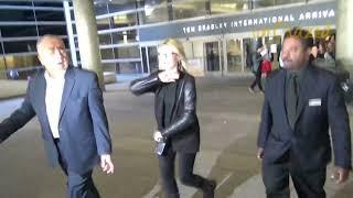 Olivia Newton-John having fun with fans and joking around with security at LAX airport