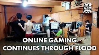 Online gaming addicts in cafe continue playing through typhoon flood  New York Post