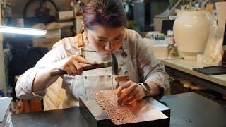 The process of making a table light with over 200 cherry blossom leaves pattern.