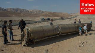 People Take Pictures Next To Remnants Of Iranian Missile That Landed In Southern Israel