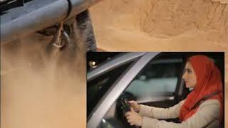 An arabian women in car but car stuck in sand