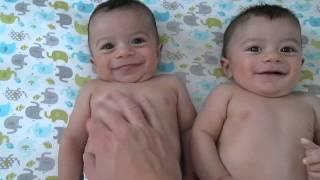 Cute twin babies tickled and laughing