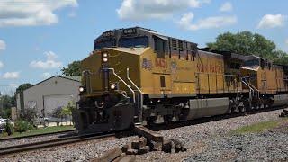 FAST FREIGHT TRAINS ON THE UNION PACIFIC CLINTON SUB UNLOADING A RAIL EXCAVATOR AND DRONE VIEWS