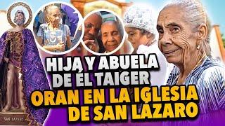 Abuela e Hija de El Taiger oran en Iglesia de San Lazaro en La Habana.