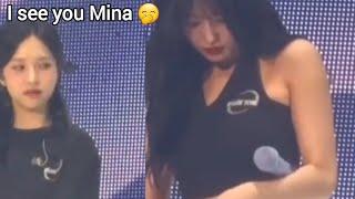 Mina looking at Momo fixing her pants 