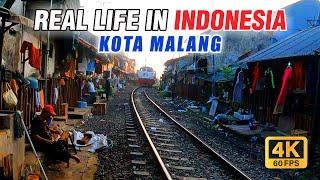 Walking tour slum area on the edge of the train tracks in Malang City Indonesia 