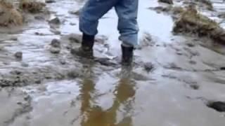JCB rigger boots walking in mud