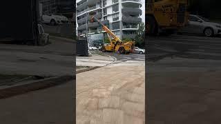 Mobile crane moving large sign